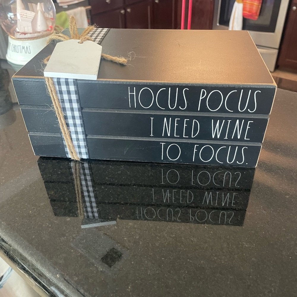 Black Decorative Book Stack with White Text